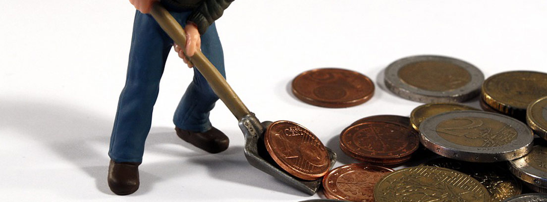 muñeco recogiendo con una pala monedas de euro